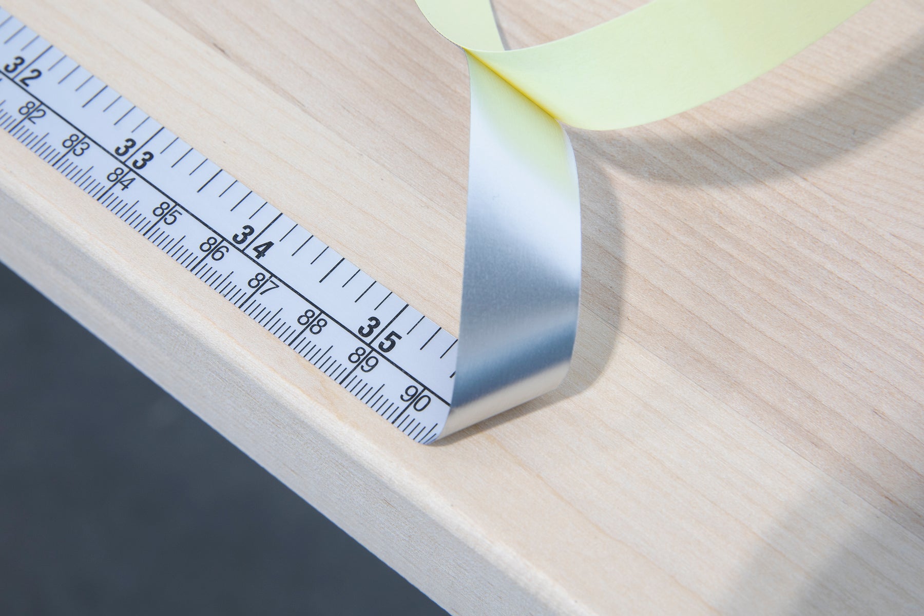 Tailors tape measure cut out against a white background. Blue